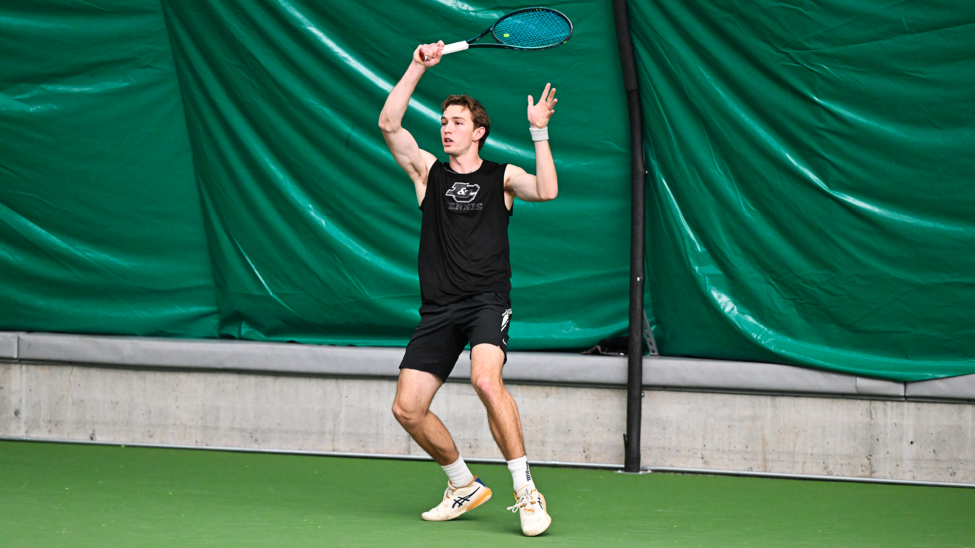 Wade McDermott follows through on a baseline forehand.