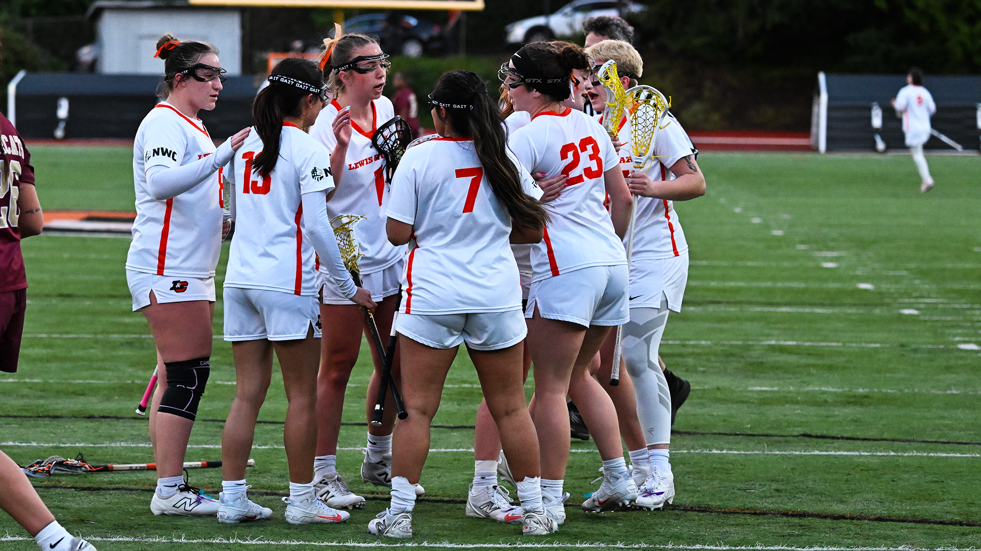 Women's Lacrosse players celebrate after a goal in a recent game. 