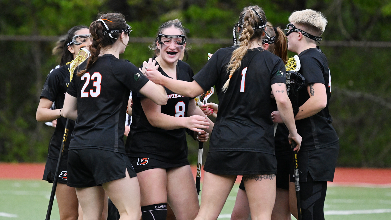 Women's lacrosse celebrates Rowan Levandoski after Levandoski scores 