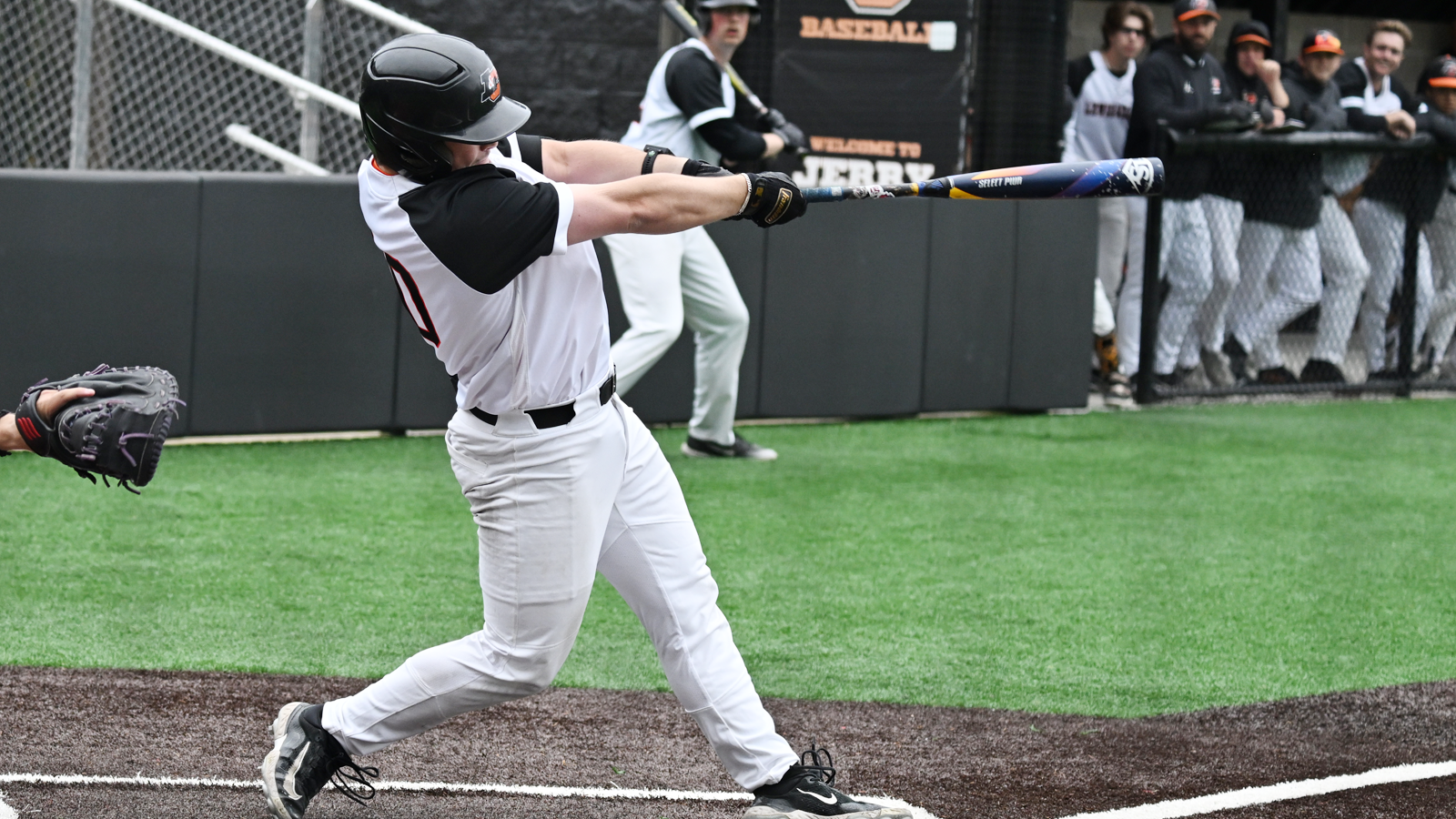 Evyn Lewis swings and hits the ball into the outfield
