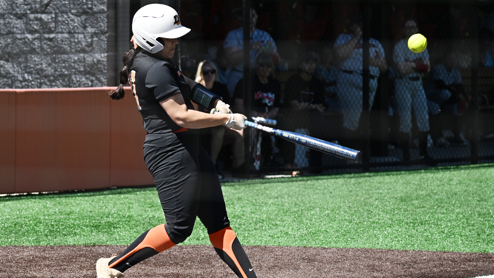 Cami Restagno swings and hits a fly ball against Pacific