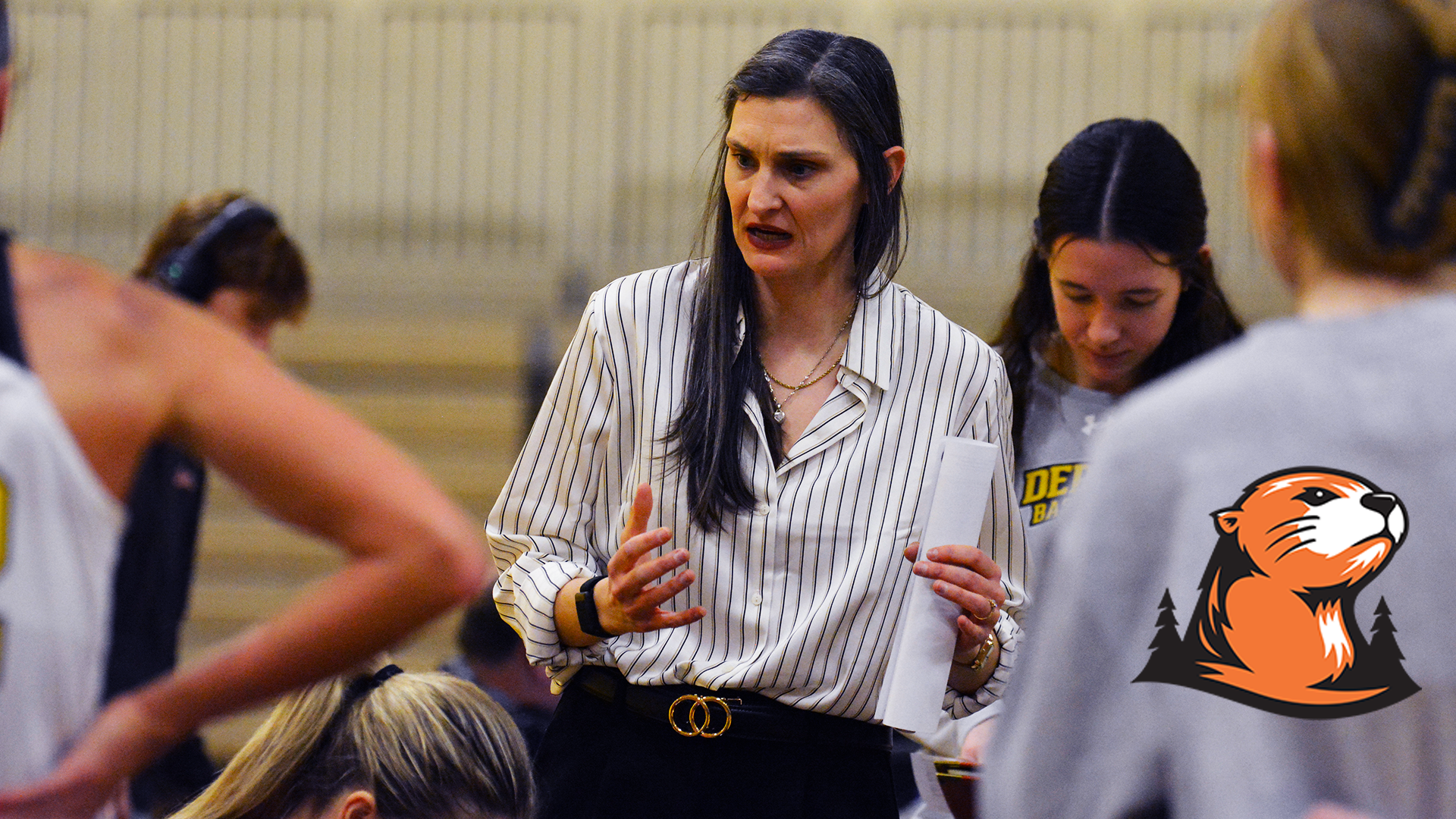 Annie Bourne is in the center of her players coaching. 