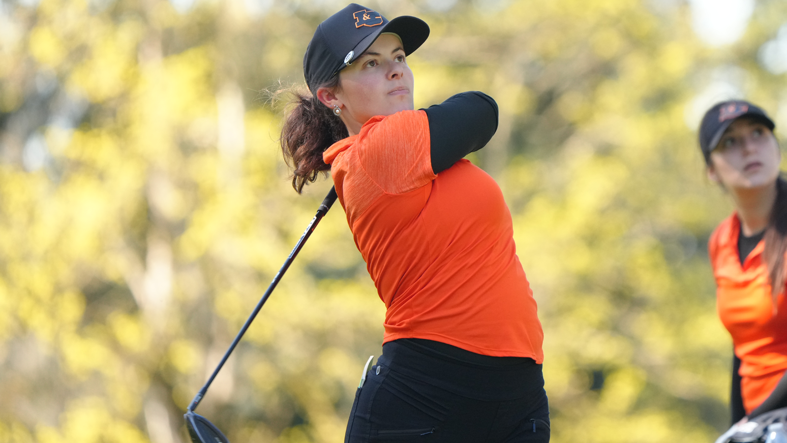Evie Denton hits a driver shot and watches the ball fly 