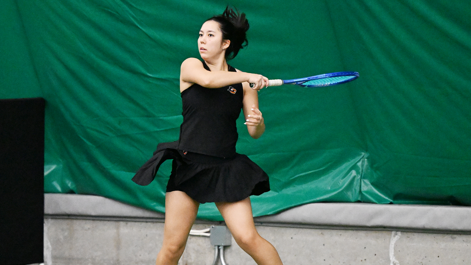 Alex Mignogna watches her forehand shot fly across the net