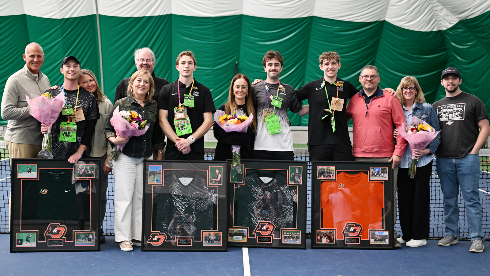 Men's Tennis' 2026 seniors pose for a photo with their families before their Senior Day match
