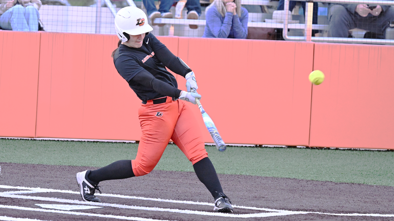 Harper Campanella swings and hits a long fly ball