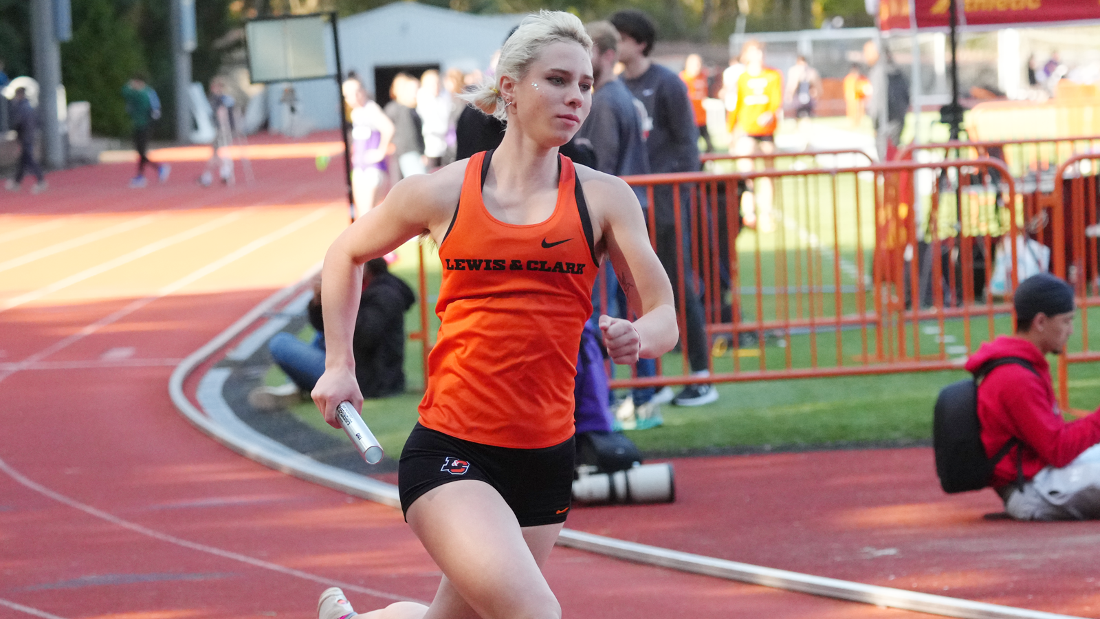 Miriam Reside runs with the baton at the L&C Electric Forest Open Meet