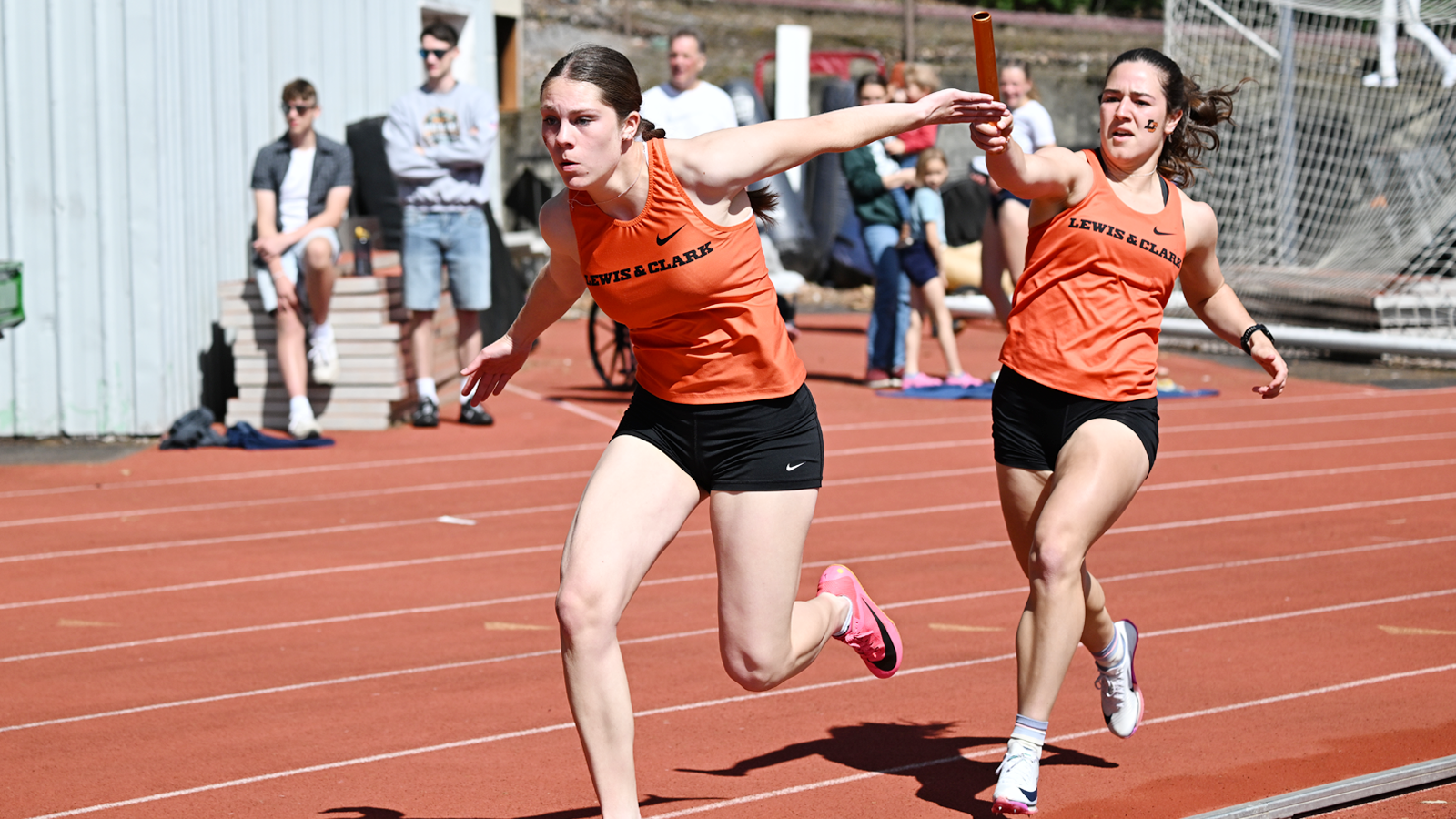 Sofia Figueroa grabs the baton from Callow Soto during the 4x100M Relay