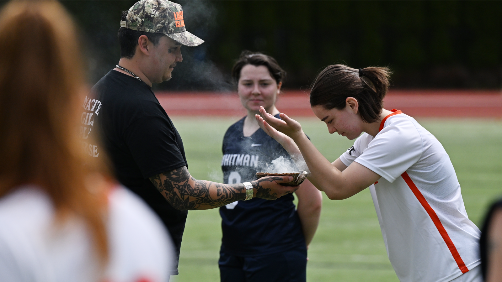 Sophomore Ava Mullen takes part in a Native American ritual before the team's game against Whitman