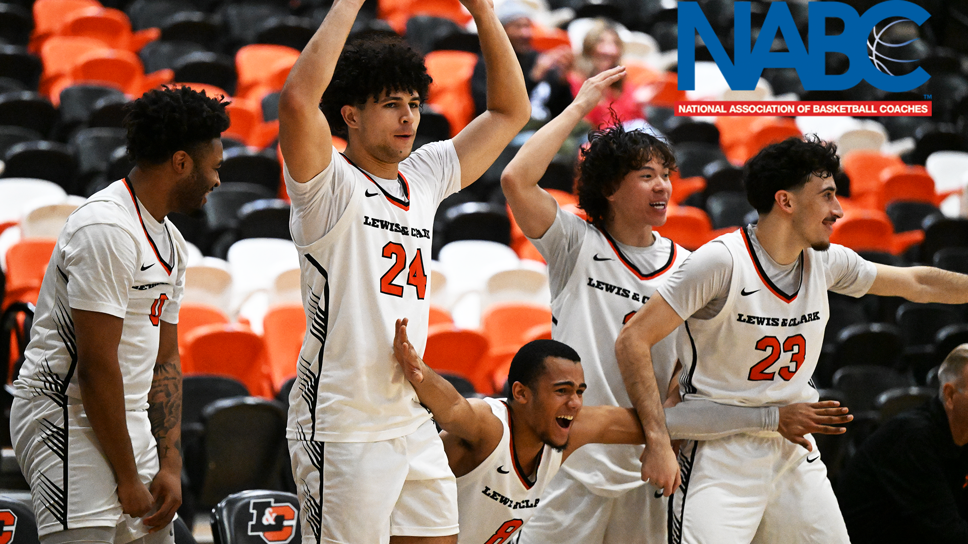 Members of the men's basketball team celebrate a play. 
