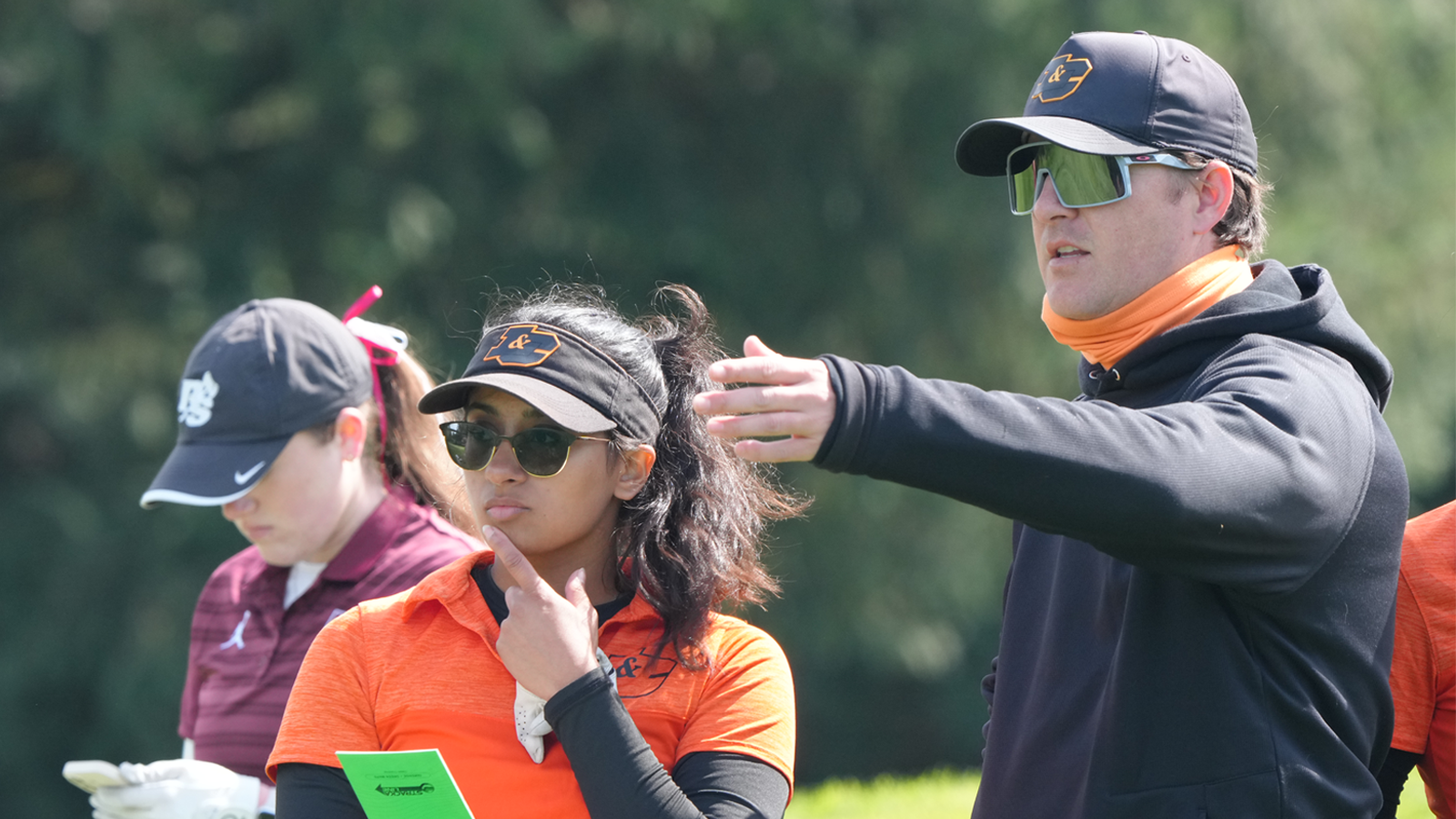 Brad Breier gives instructions to Ahika Jani before she hits a shot