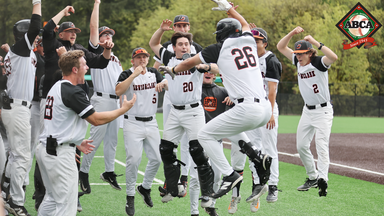 Baseball players jump up and celebrate together after a Will Michelman home run