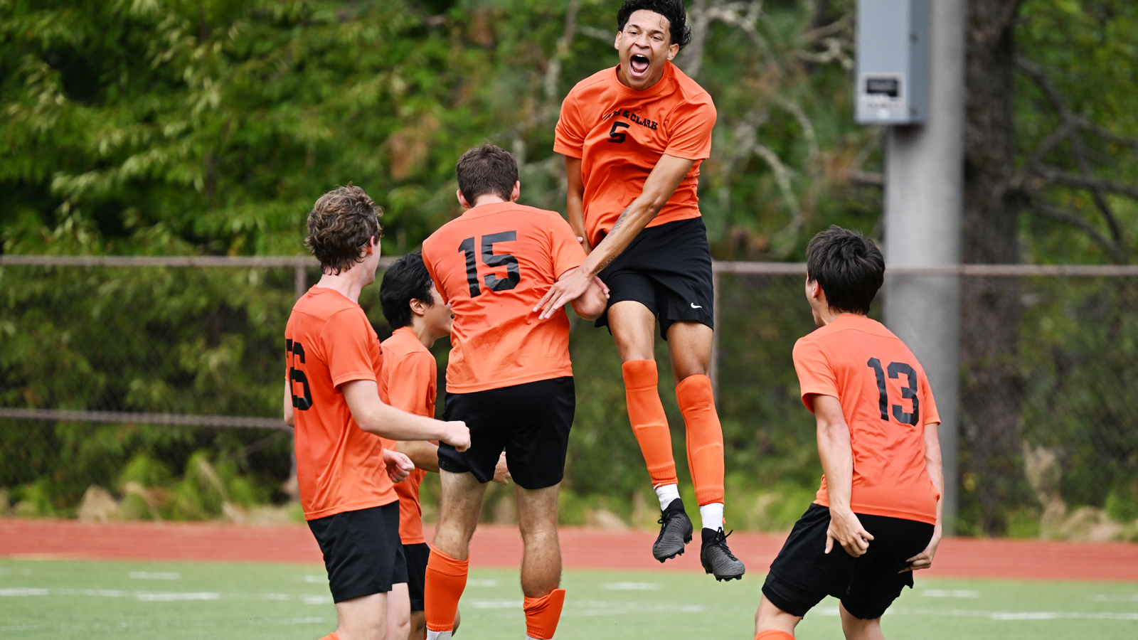 Men's Soccer plays jump up and celebrate together after scoring a goal