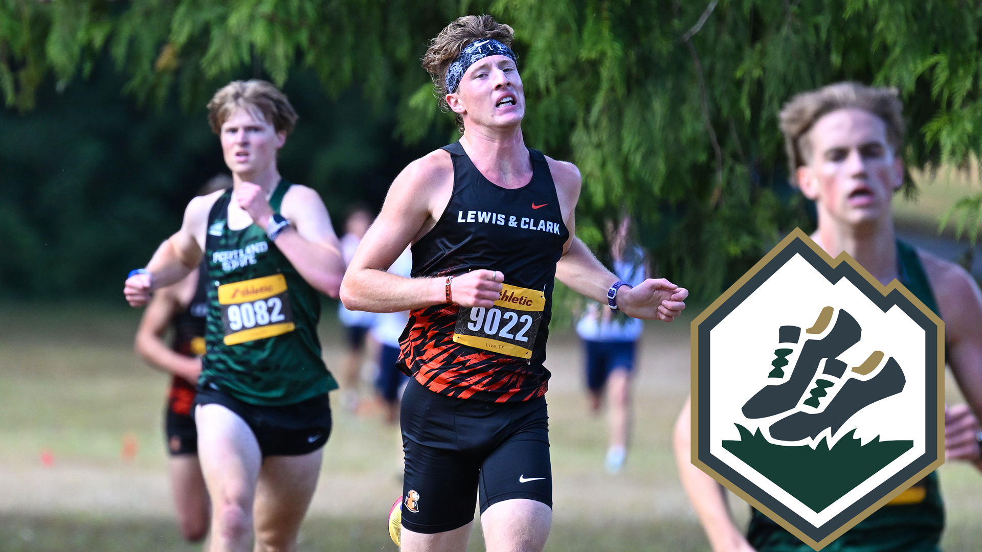 Quinn Higgins runs between two Portland State runners. 