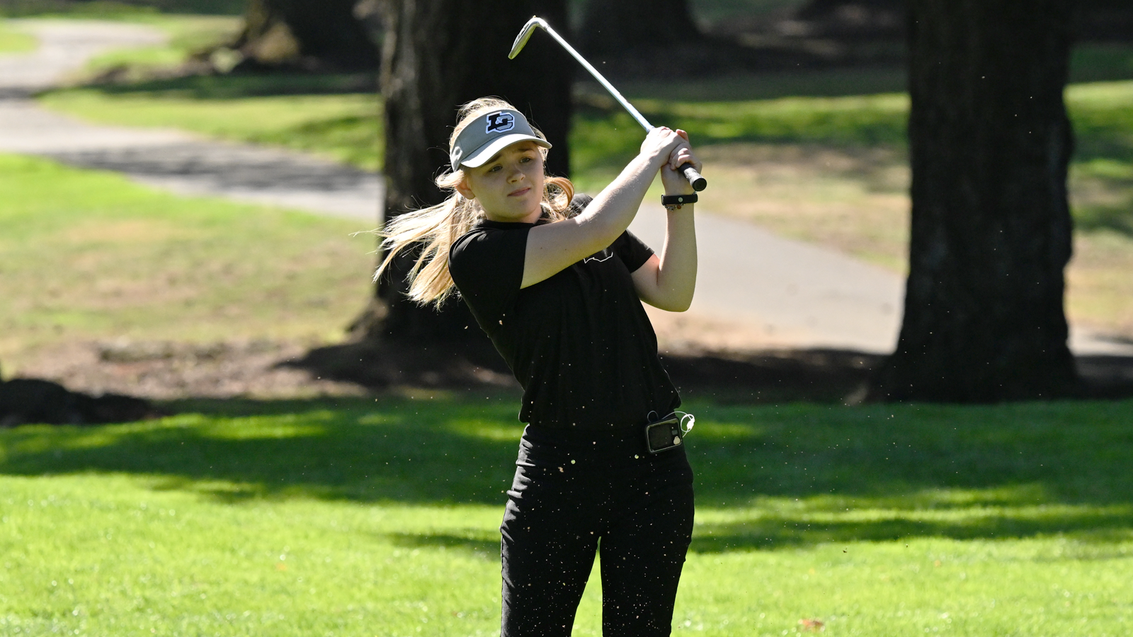 Lauren Raitanen hits an iron shot and watches it fly towards the hole