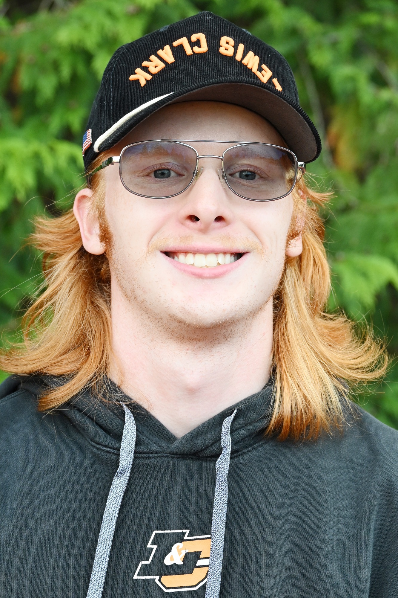 Patrick Abendroth smiles in front of a green backdrop 