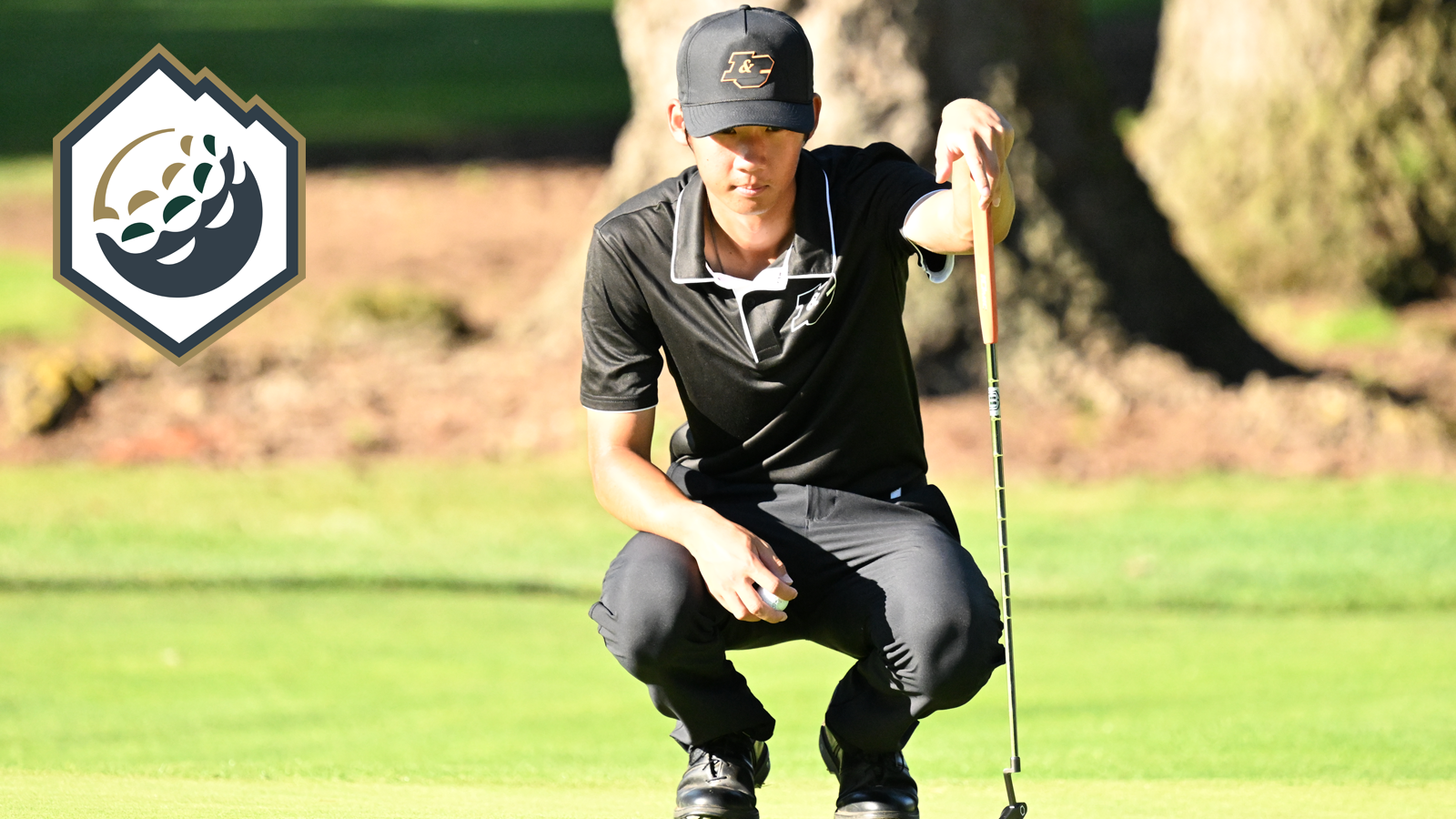 Joonho Moon crouches down and looks at his line as he gets set to putt