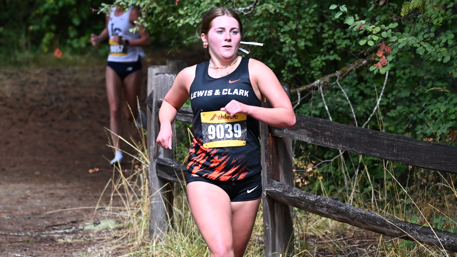Ava Stewart runs along the river at the Lewis & Clark XC Opener