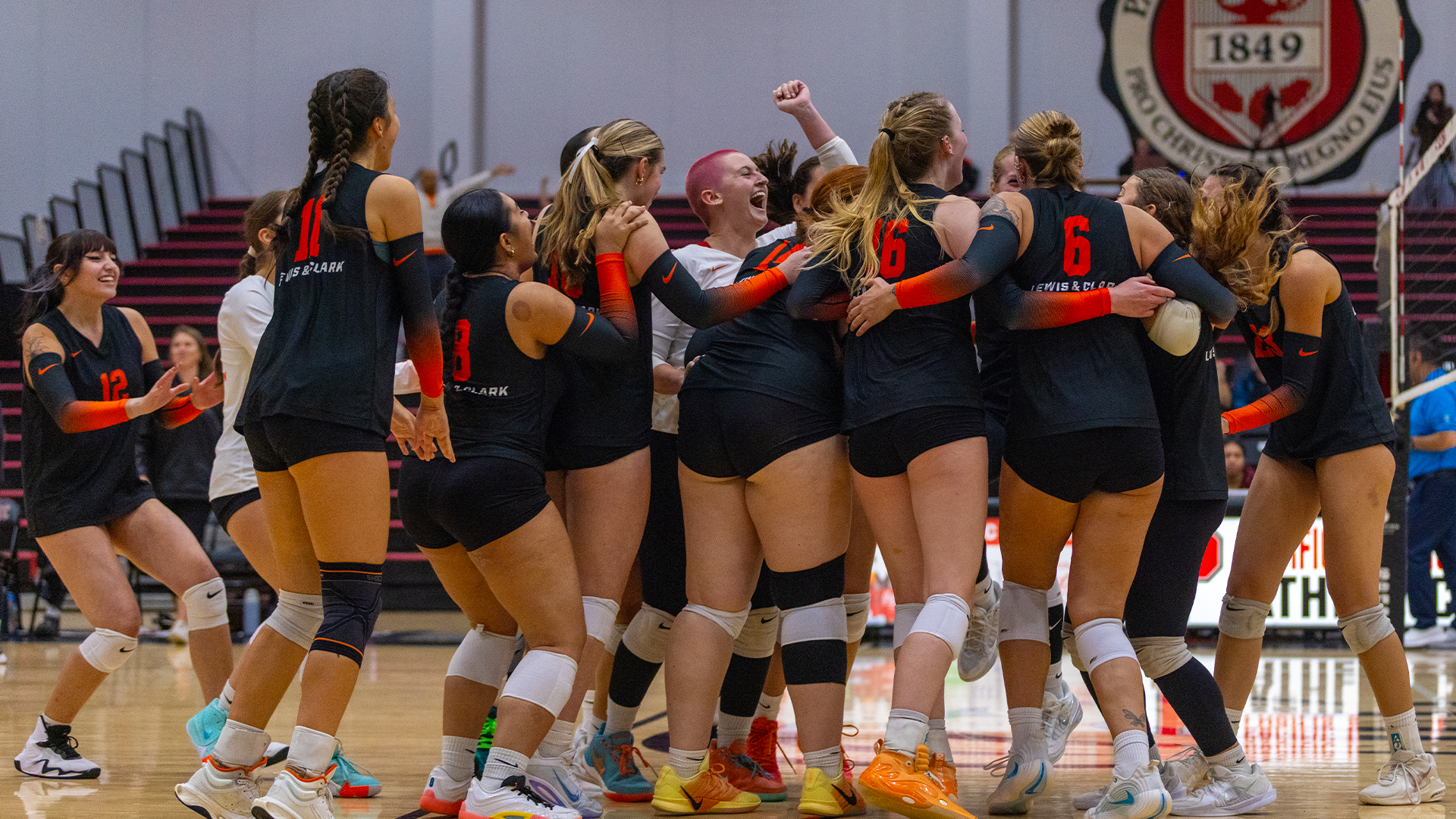 The women's volleyball team celebrates after a win. 