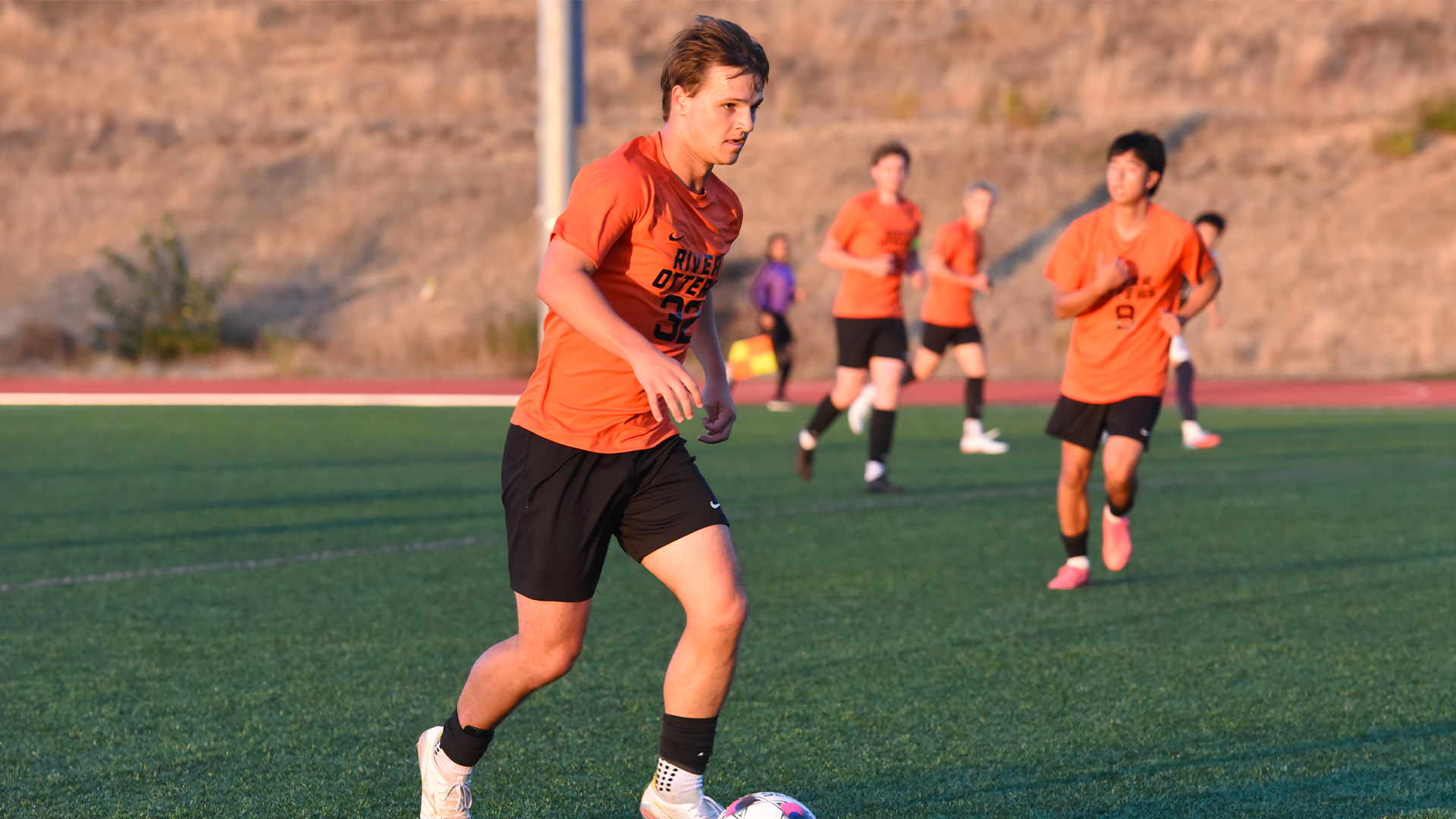 Raff Ladd kicks the ball in the game against Corban