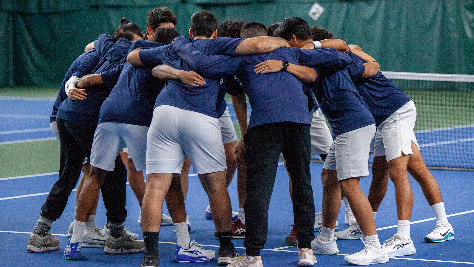 Men's tennis team huddle