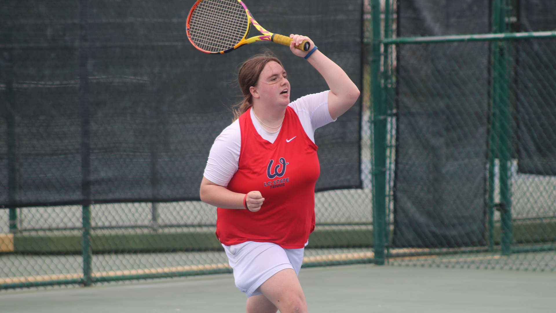 Ryle Gettmann swings a tennis racquet