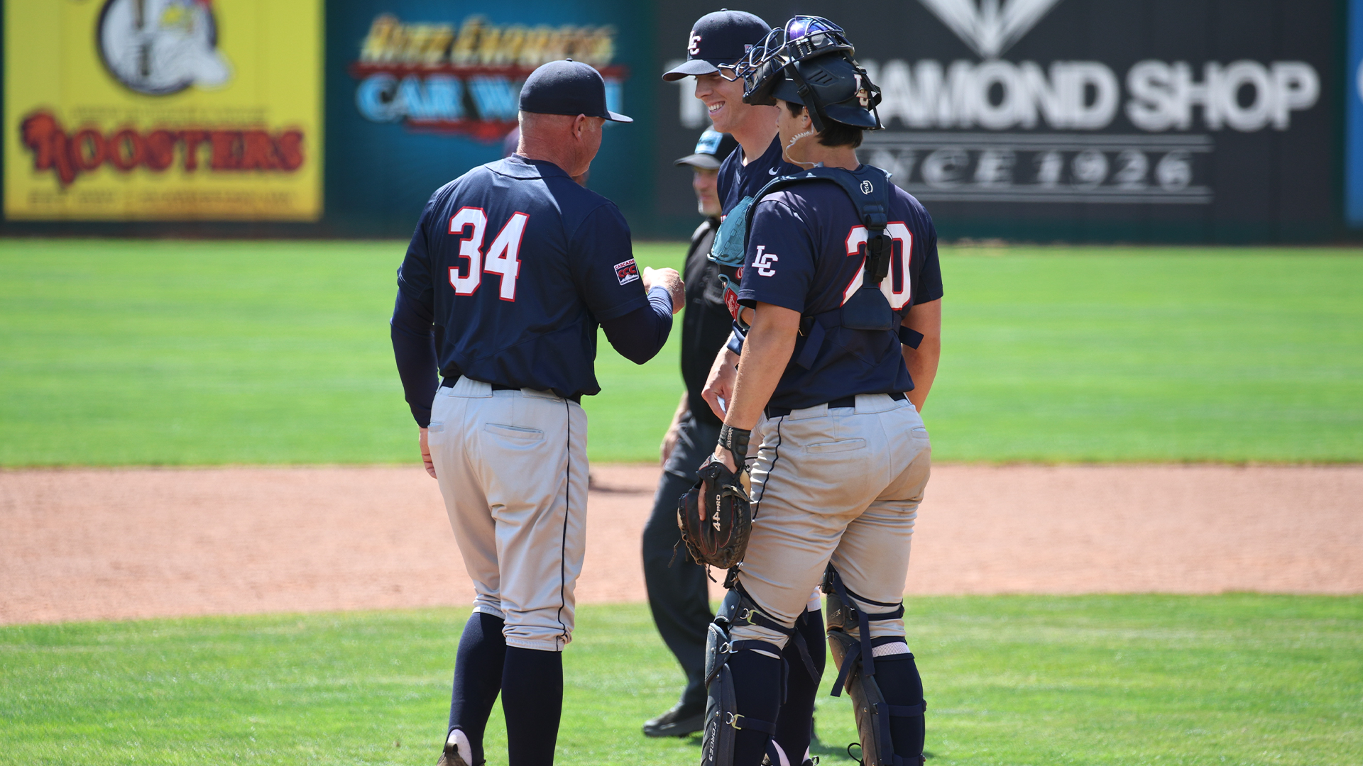 Jeremiah Robbins fist bumps Zach Elsos as he changes pitchers
