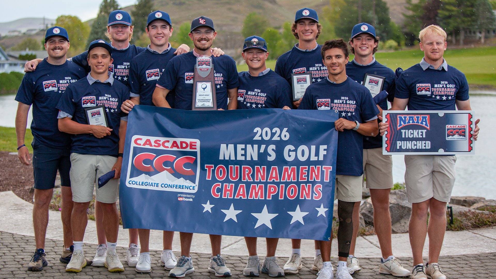 Men's golf team poses with championship banner