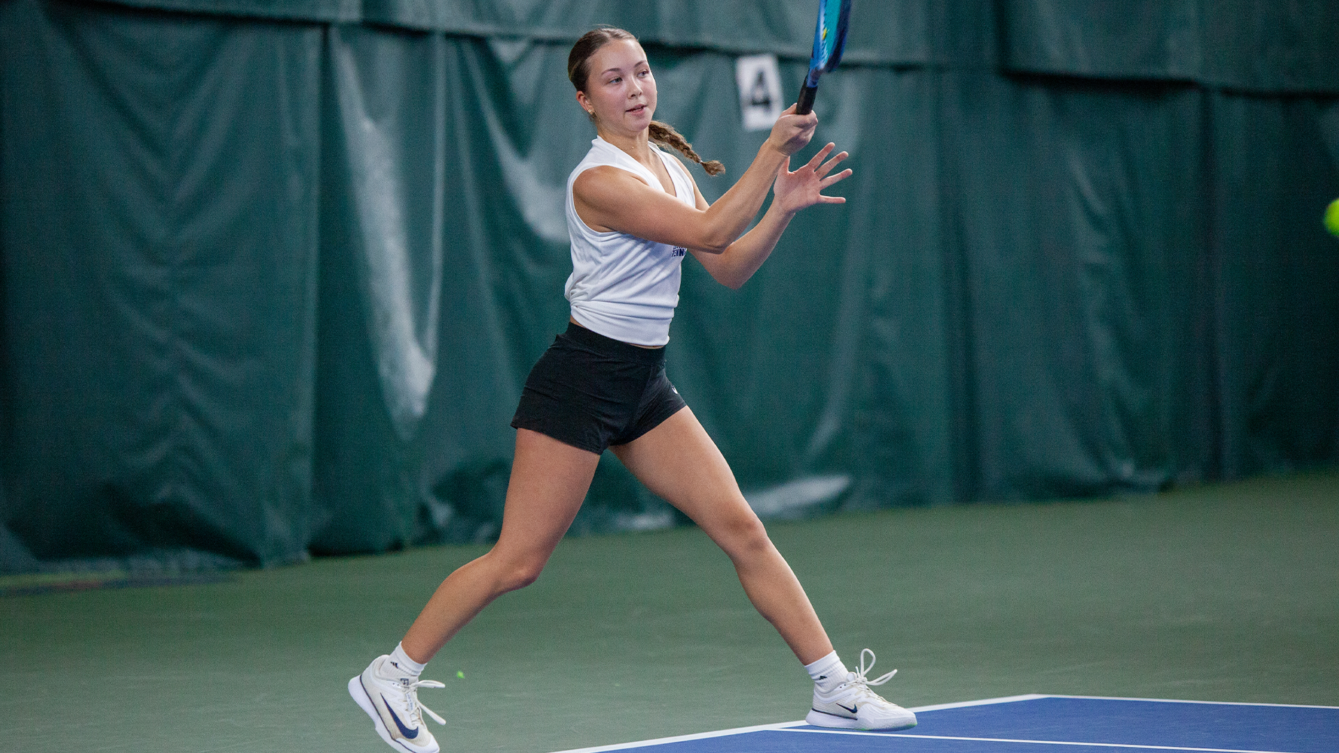 Gwyn Heim hits a tennis ball