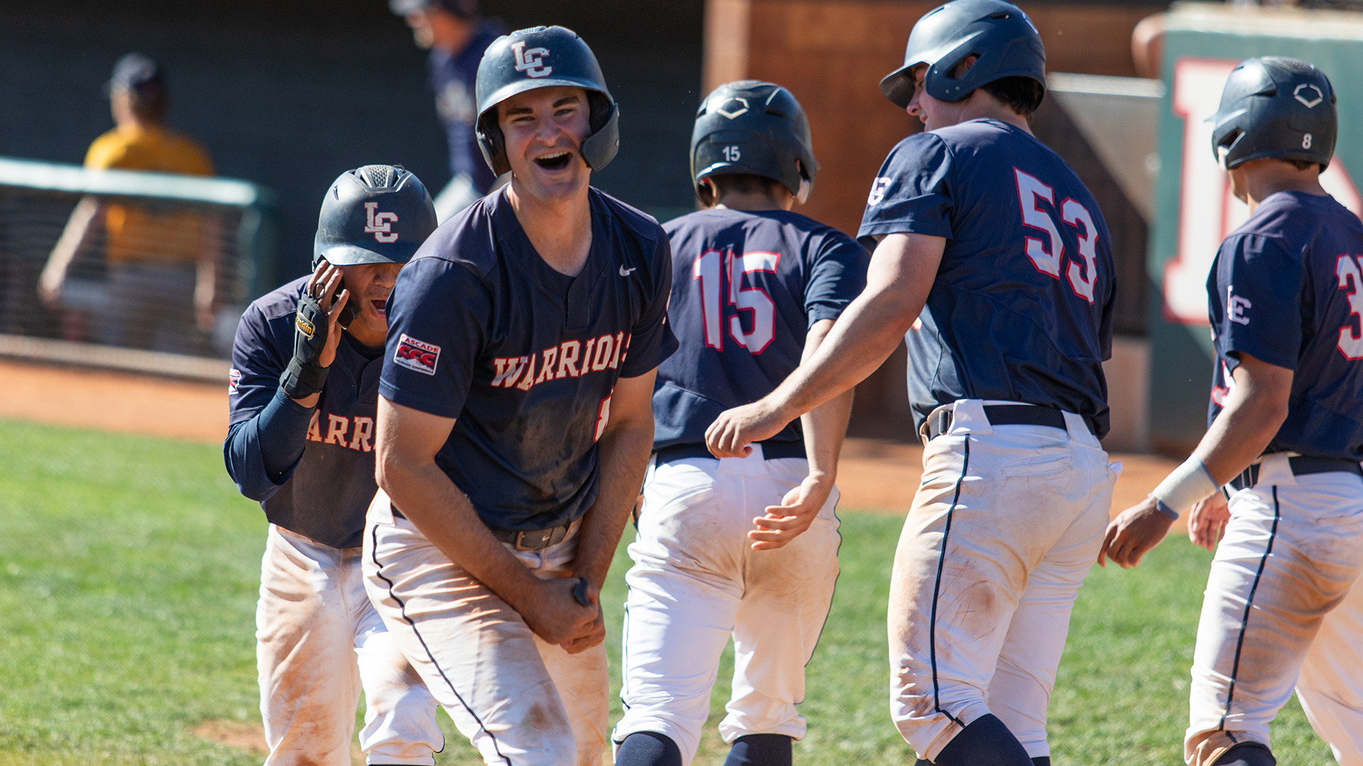 Bryce Johnson celebrates with teammates at home plate