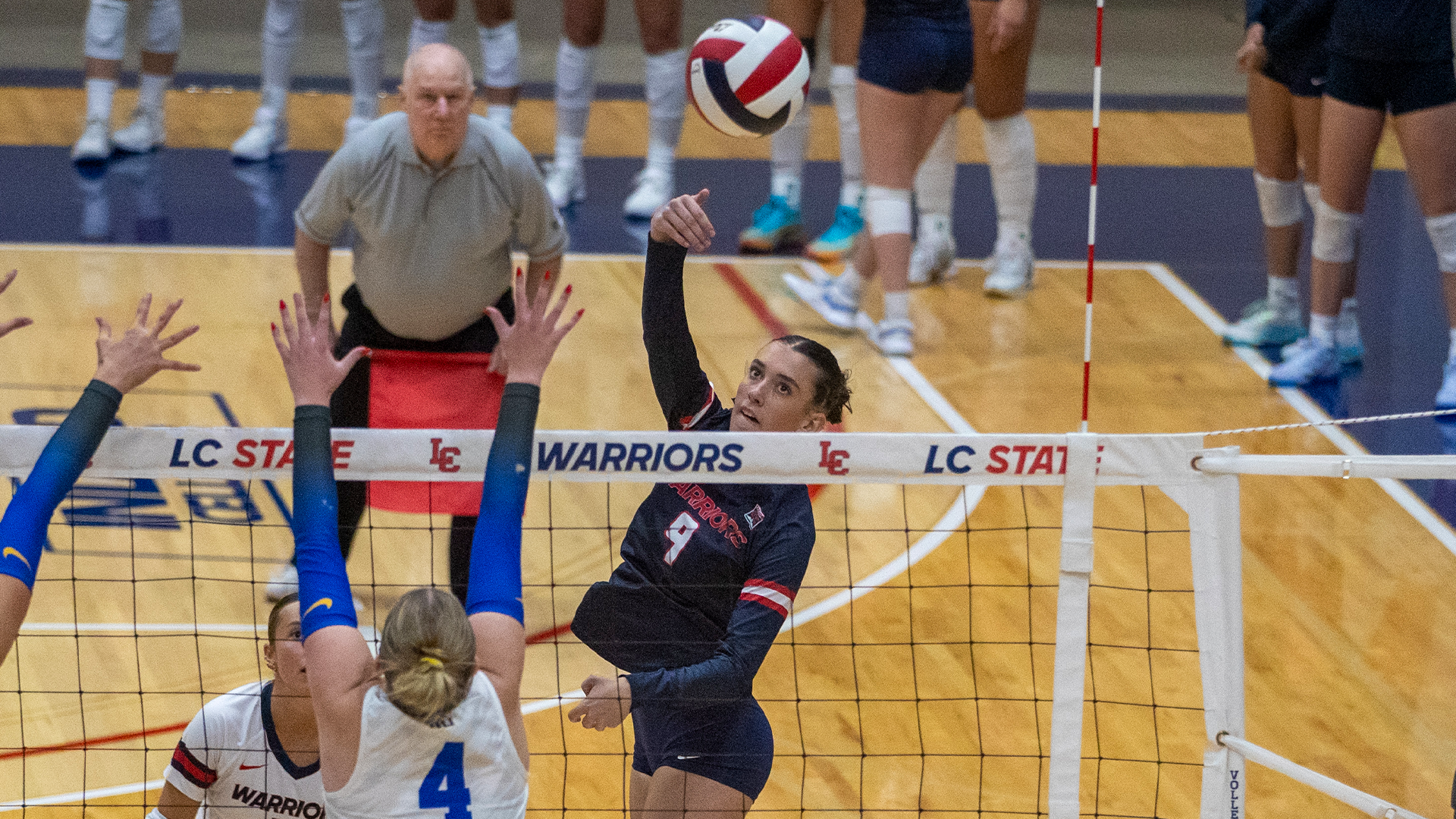 Aubree Lane hits a ball over the net