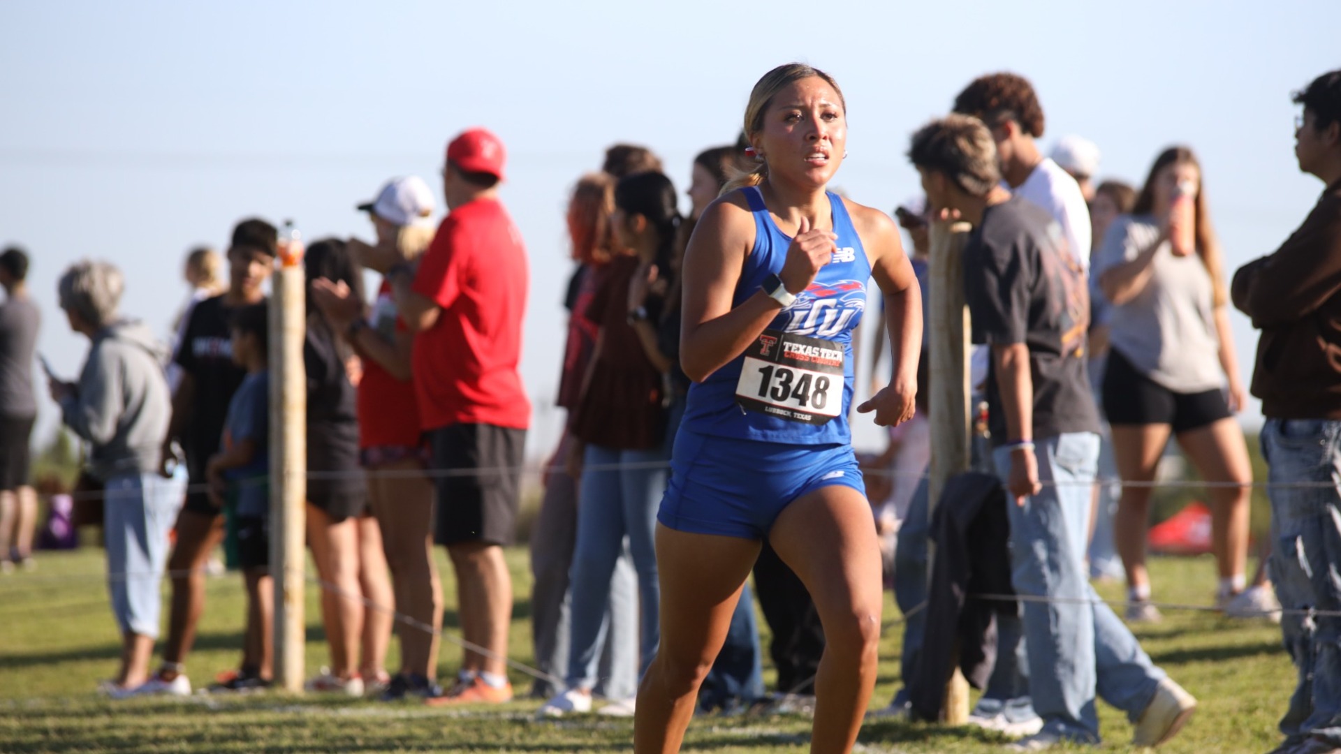 Photo depicting Lubbock Christian University Women's Cross Country runner Yahaira Martinez running in the Texas Tech Open. In a close up, Martinez is seen striding down the course.