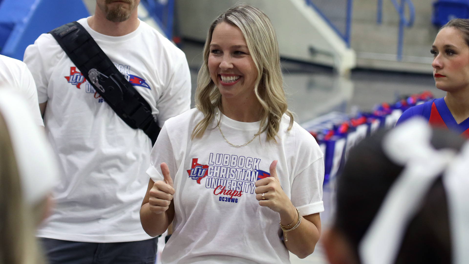 Whitney Sales smiles with thumbs up adressing the cheer squad