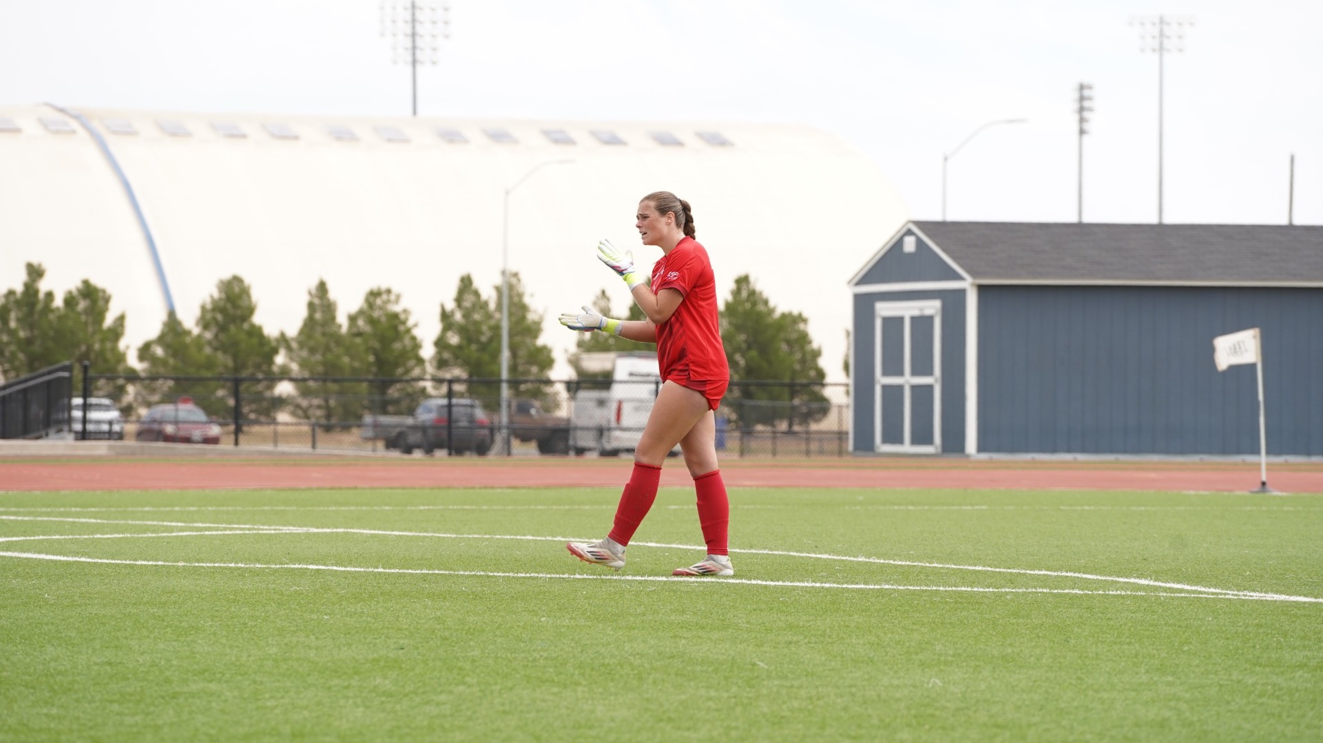 This is a photo of goalkeeper Emma Wright (red jersey) yelling at her teammates during a game at the LCU Soccer & Track Complex.