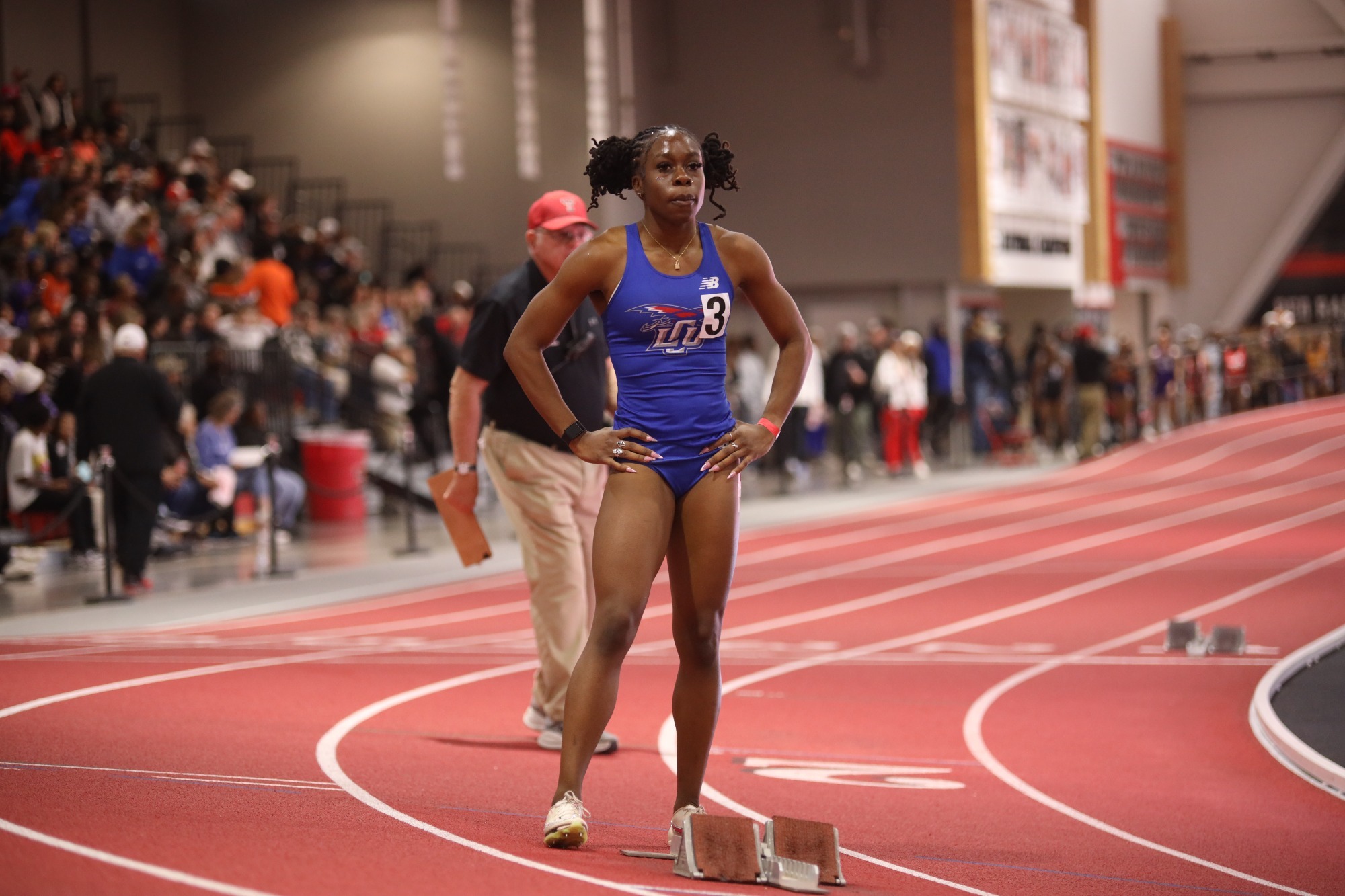 This is a photo of Lubbock Christian athlete Joy Egwu standing on a track with starting blocks in front of her before a race at the Texas Tech Sport Performance Center. 