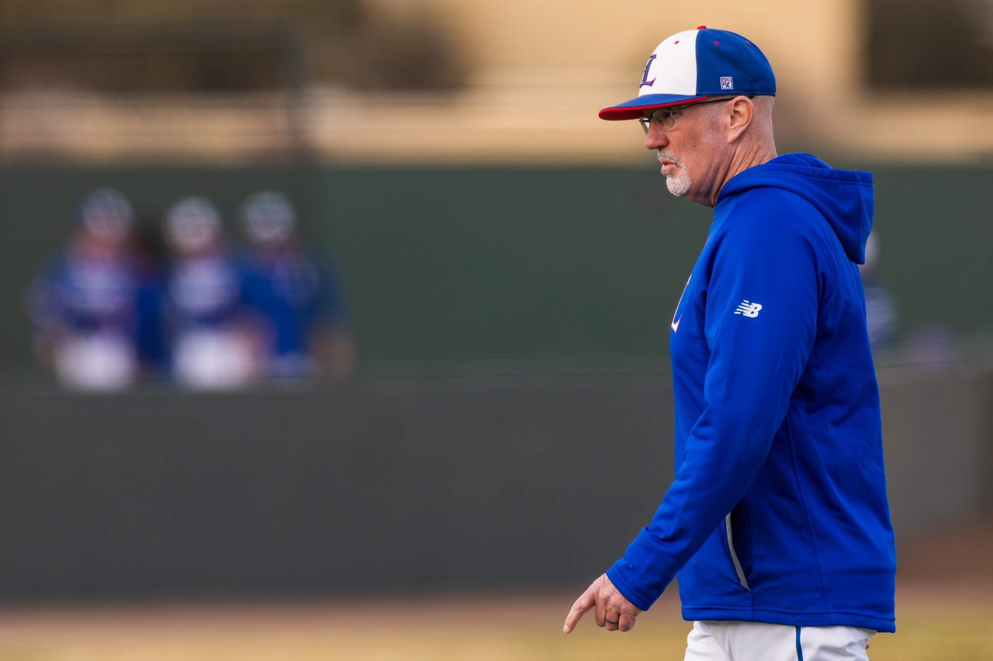 This is a photo of LCU baseball head coach Nathan Blackwood walking. 