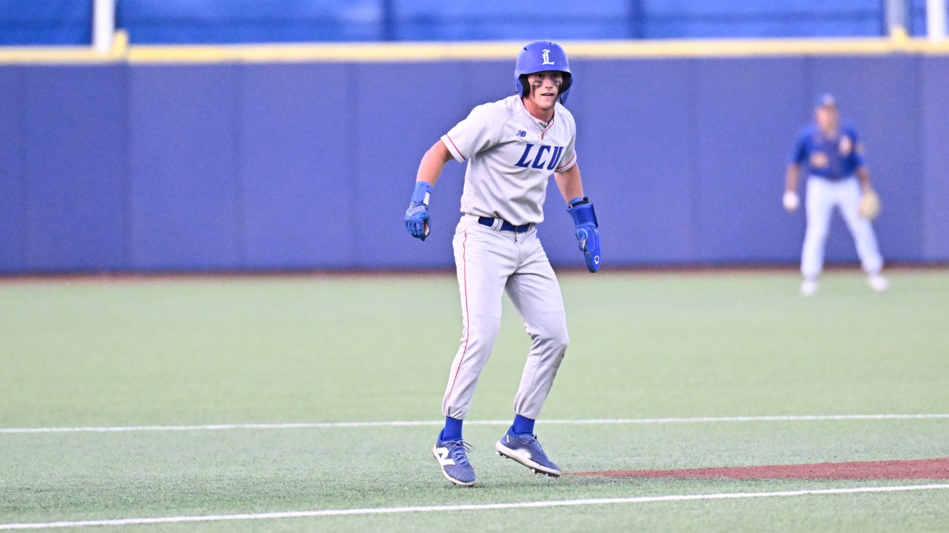 This is a photograph of Lubbock Christian outfielder Kyle Lewis taking a lead off second base during a game at Foster Field in San Angelo, Texas. 