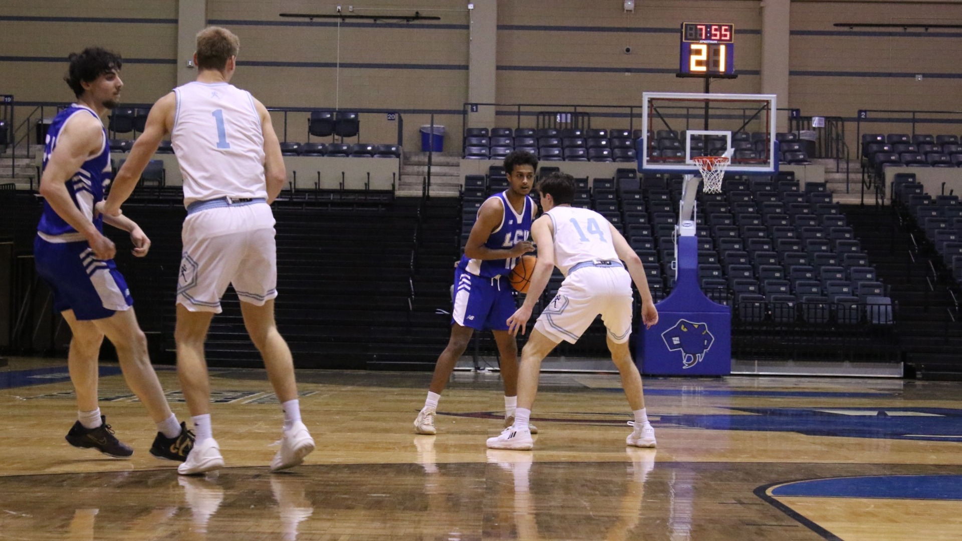 This is a photograph of Lubbock Christian guard Kendall Dow (blue jersey, #10) dribbling the basketball against a Washburn defender in a game at Bill Greehey Arena in San Antonio, Texas.