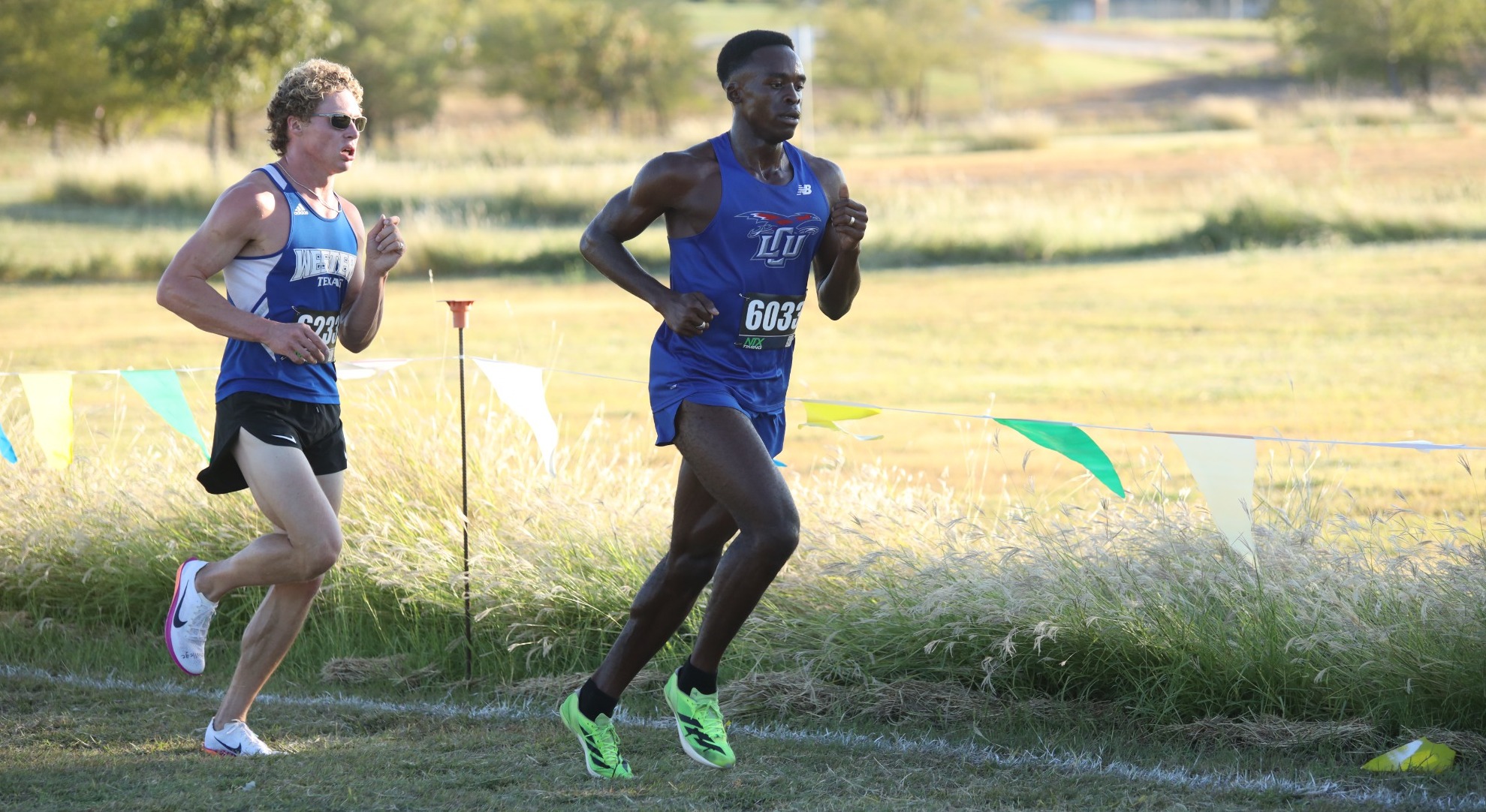 This is a photo of Lubbock Christian runner Matthew Gordon (blue uniform) running outside. 