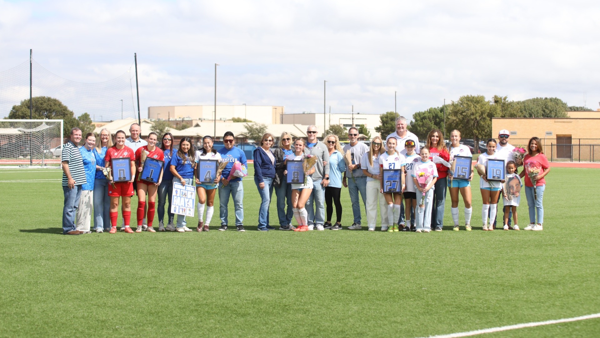 This is a photo of Lubbock Christian women's soccer seniors and their families prior to a game at the LCU Soccer & Track Complex. 