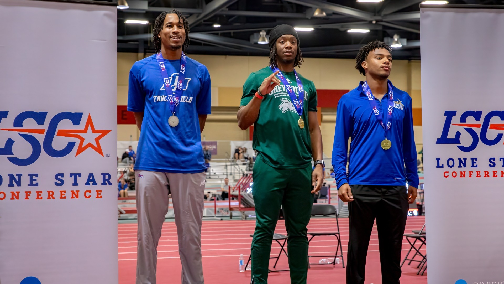 This is a photo of Lubbock Christian long jumper Maurice Gray (blue shirt, far left) on the podium with his silver medal at the 2026 Lone Star Conference Indoor Track & Field Championships.