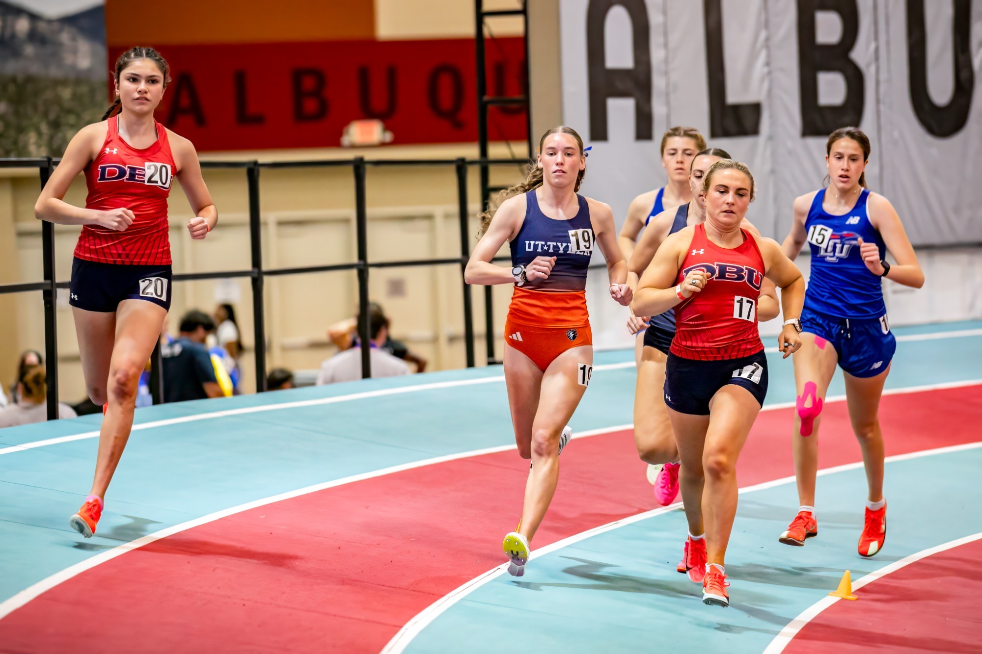 This is a photo of women's track and field athletes running. 