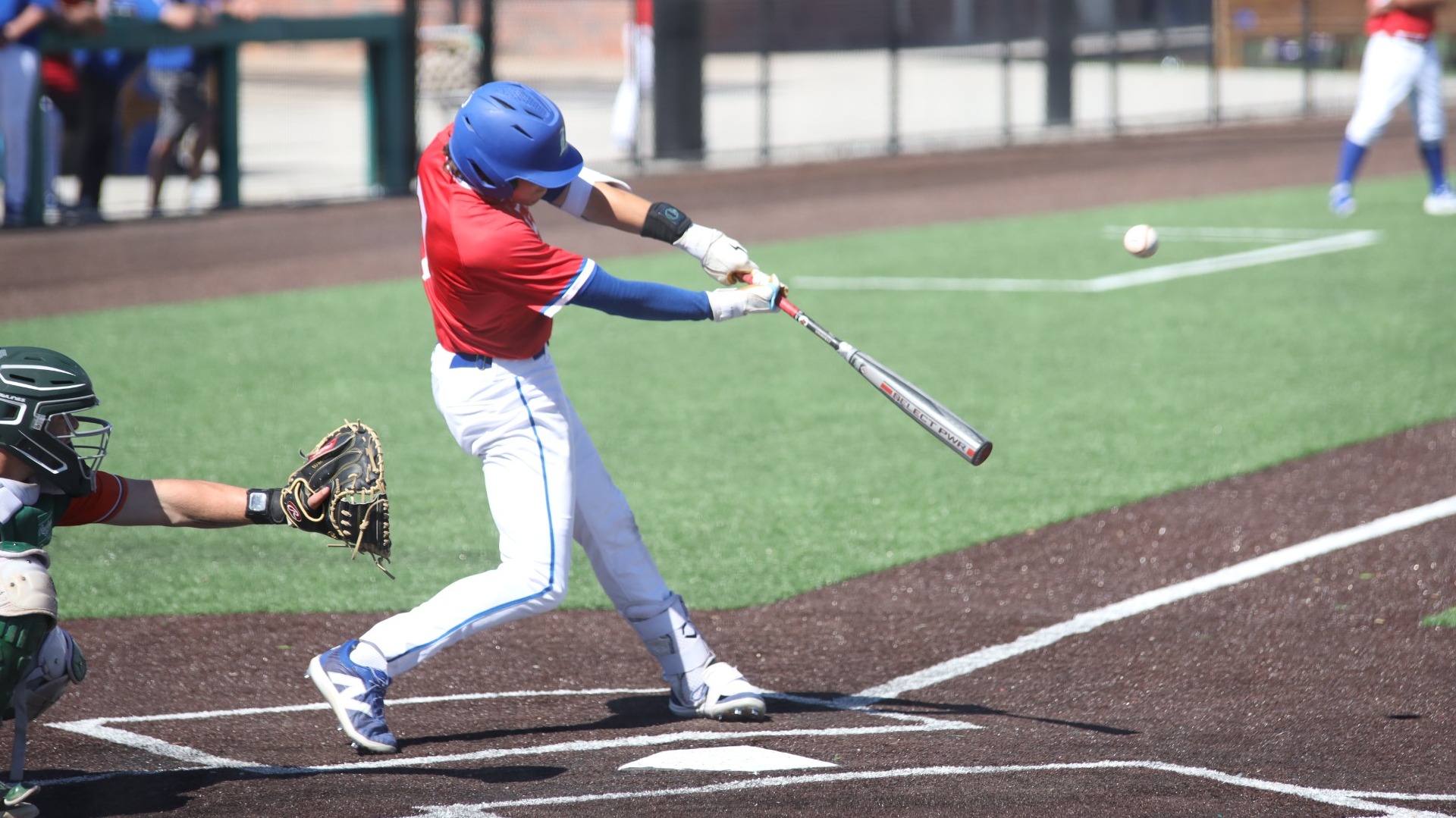 This is a photo of Lubbock Christian infielder Dylan Marx (red jersey, #7) hitting a baseball during a game at Hays Field. 