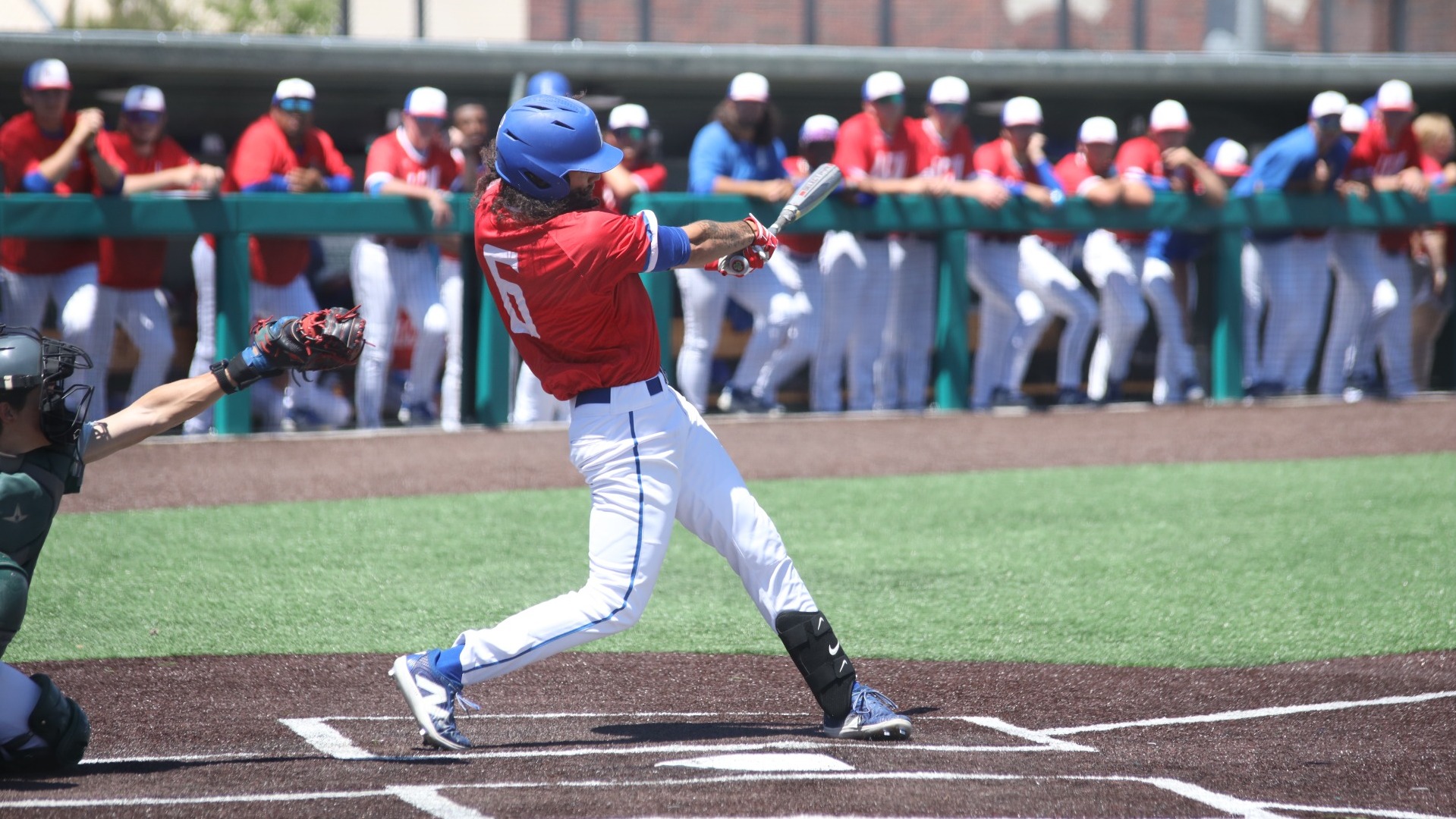 This is a photo of Lubbock Christian infielder Jorge De Los Santos (red jersey, #6) hitting a pitch during a game at Hays Field. 