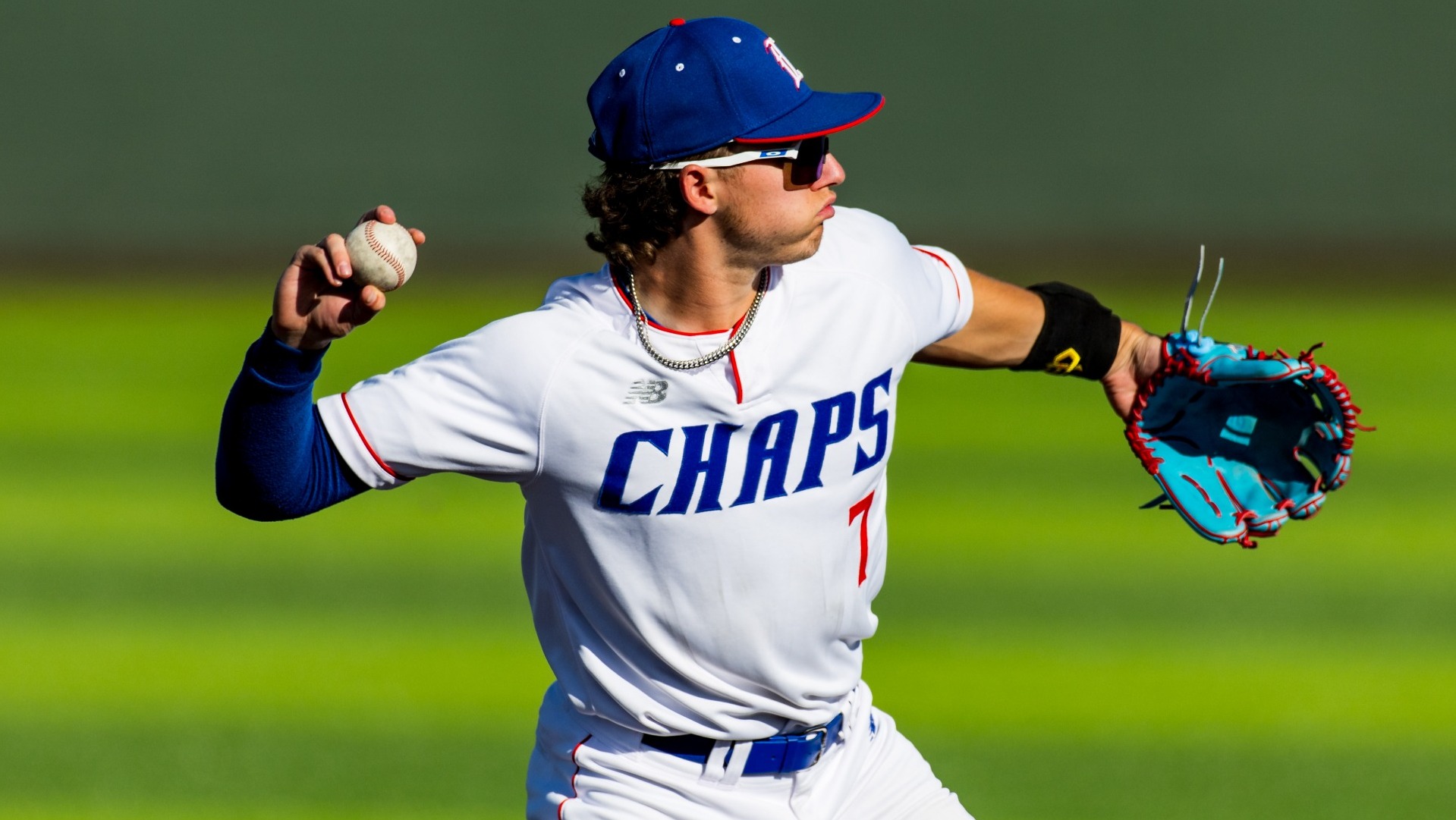 This is a phot of Lubbock Christian infielder Dylan Marx (white jersey, #7) preparing to throw a pall during a game at Hays Field. 