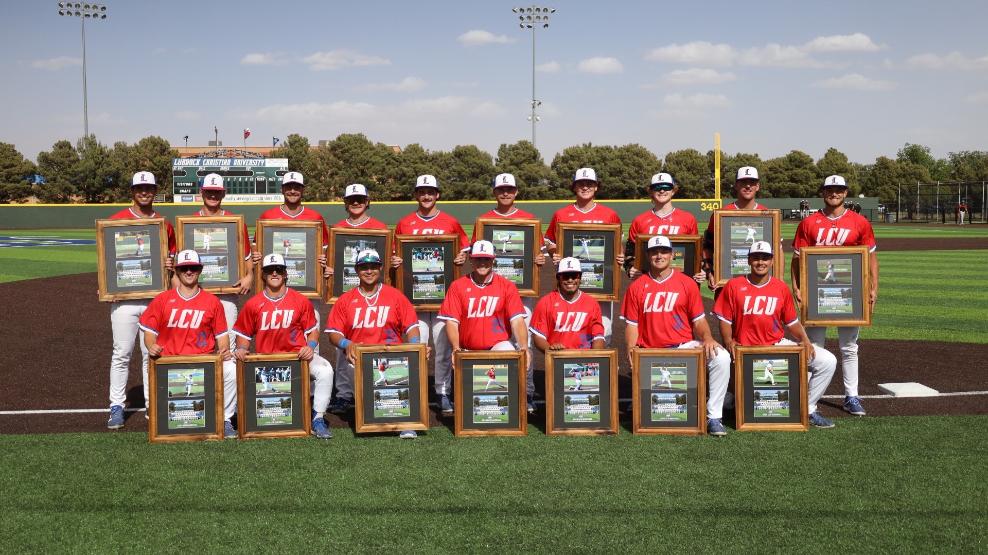 The seventeen Lubbock Christian baseball seniors (wearing red jerseys) pose for a photo with their senior day gifts at Hays Field 