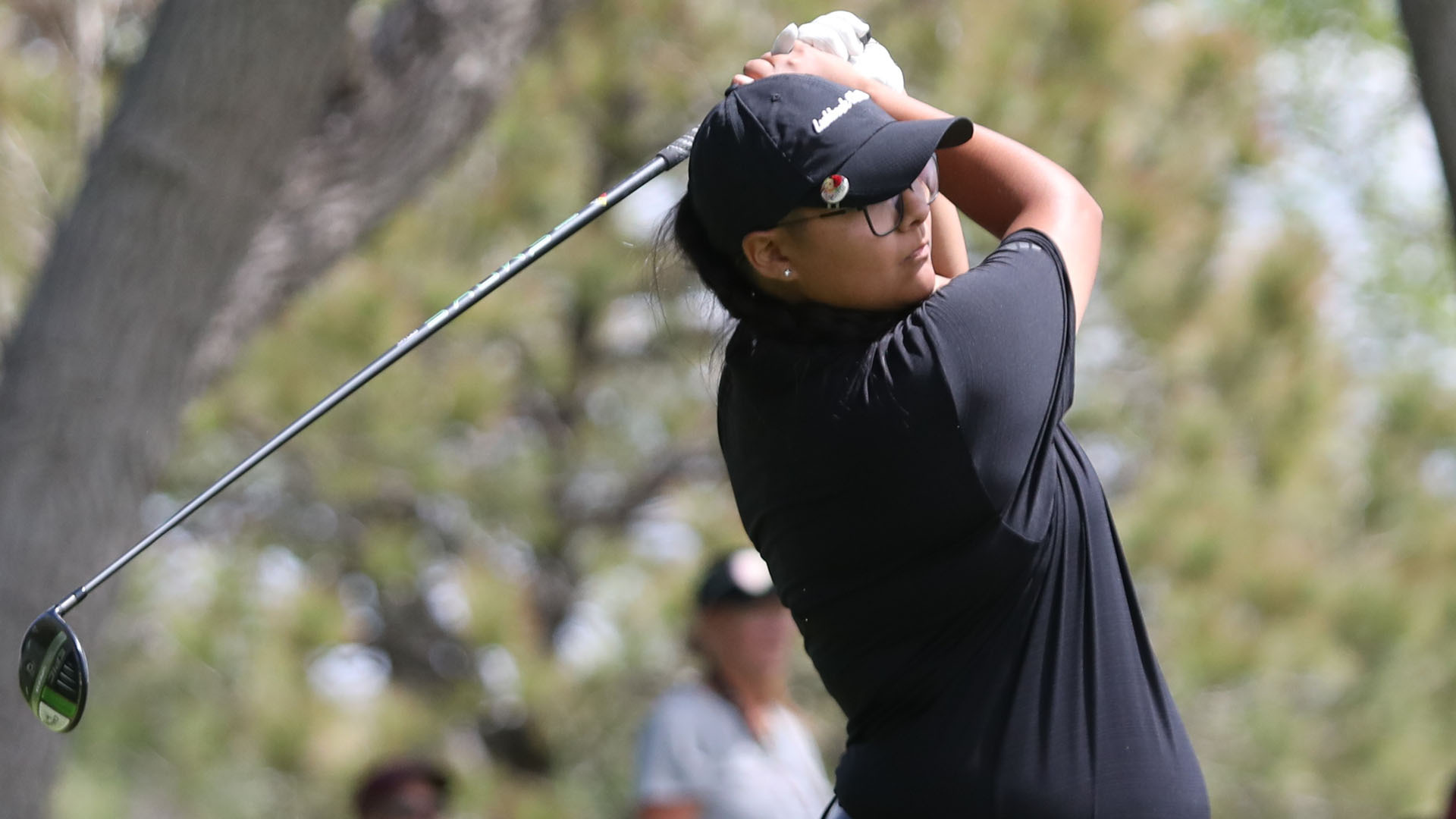 A Lubbock Christian University Lady Chaps golfer wearing all black, including a black 