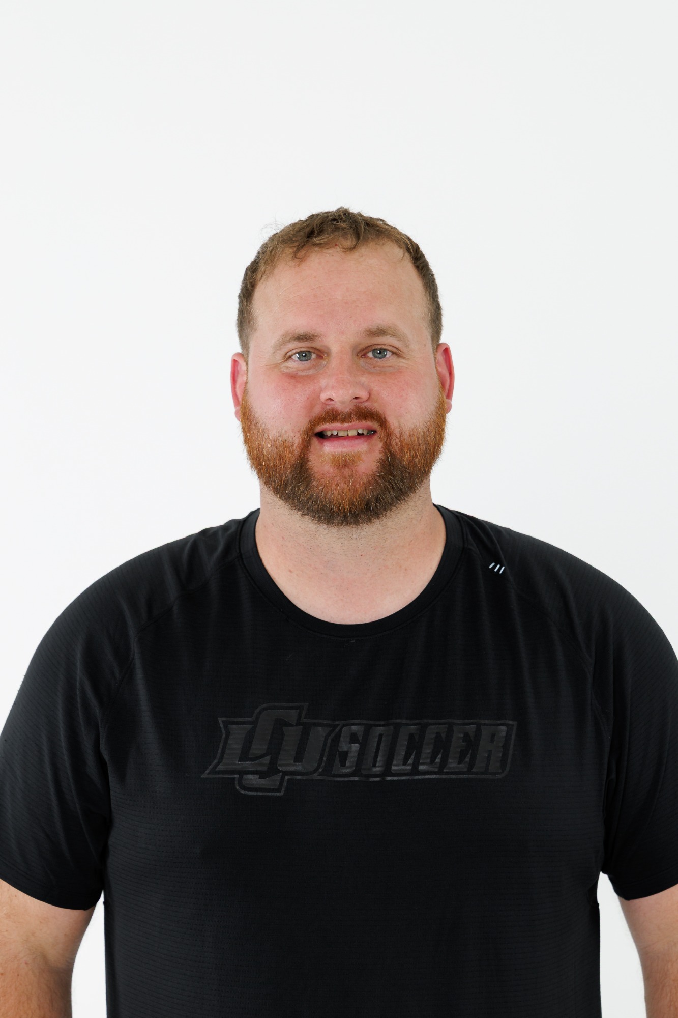 Head shot of an LCU men's soccer player in a black polo