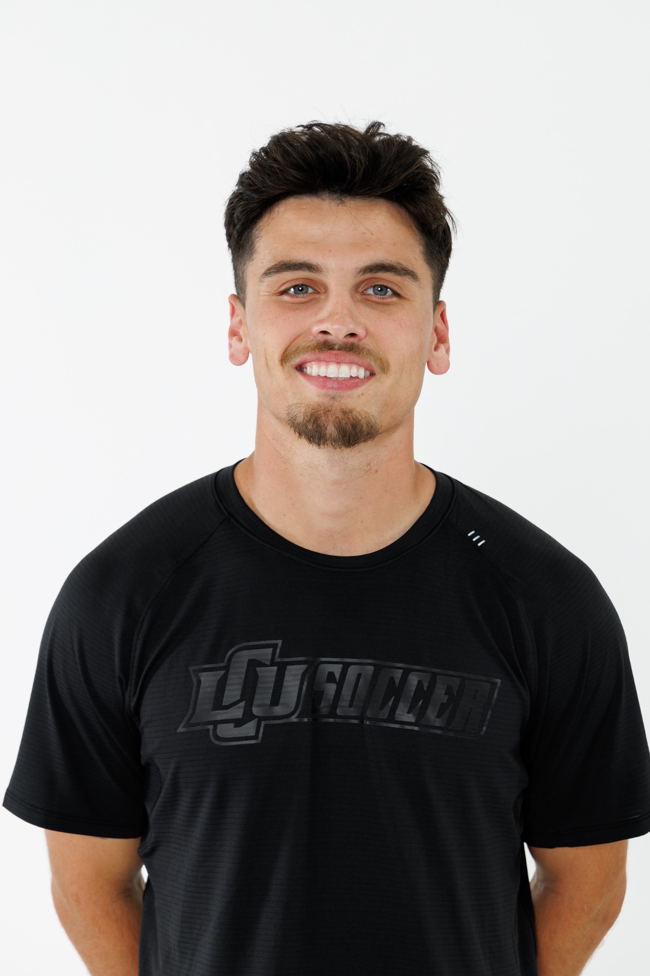 Head shot of an LCU men's soccer player in a black polo