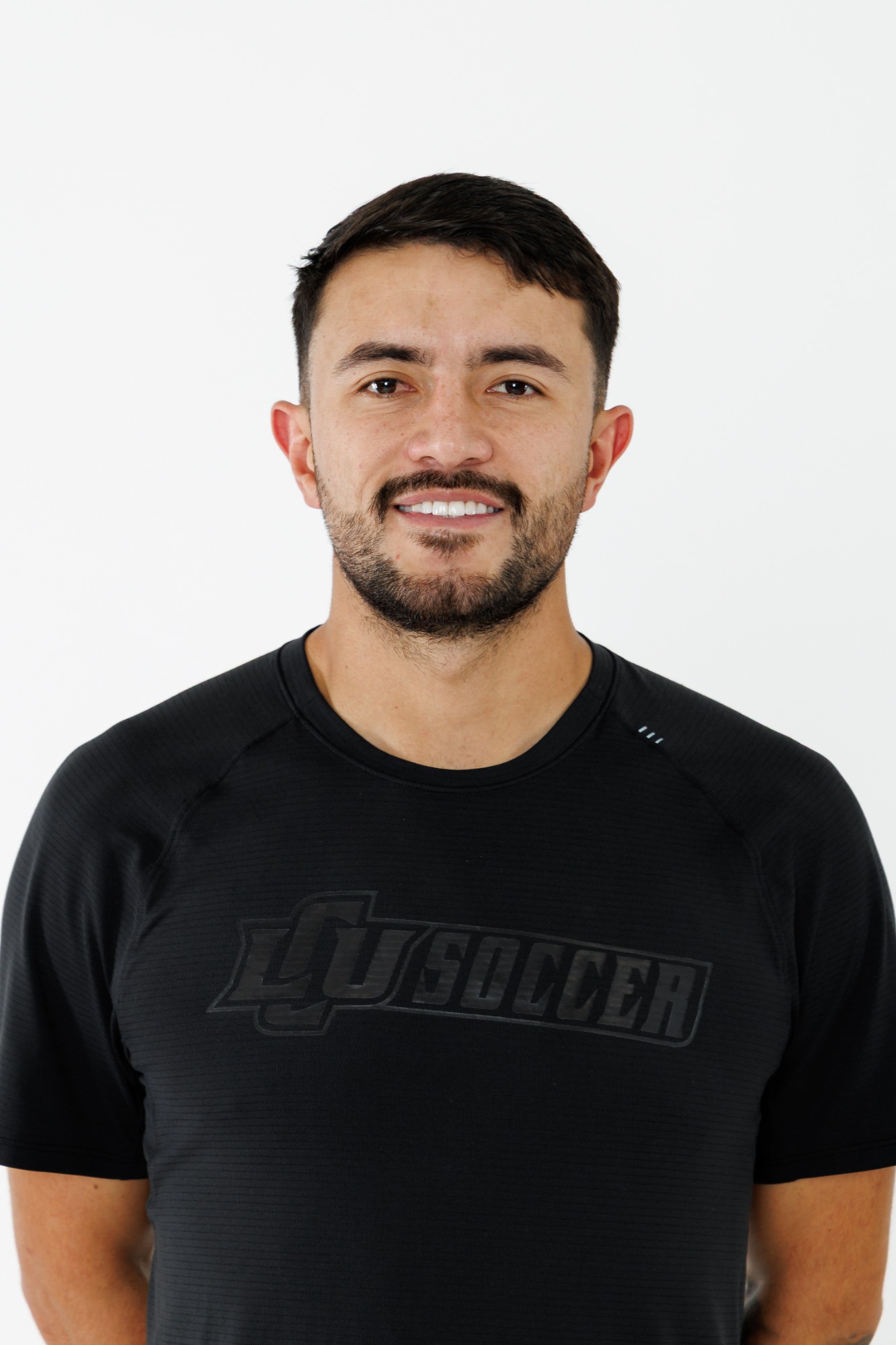 Head shot of an LCU men's soccer player in a black polo